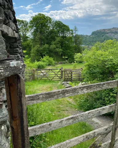 Wooden gates leading to lush green meadow in Chapel Stile