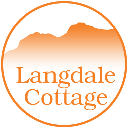 Langdale Cottage in front of Langdale Pikes silhouette